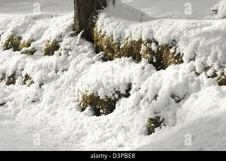 Snow banked up against a dry stone wall in rural Aberdeenshire Stock Photo