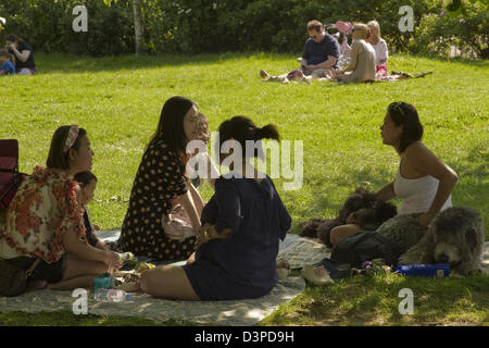 South-East Asian family and friends enjoying day out in Hyde Park Stock Photo
