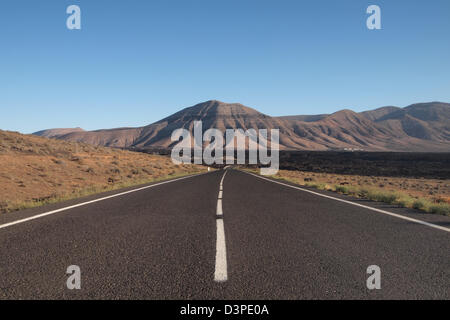 road through lava fields in timanfaya national park, lanzarote spain canary islands Stock Photo