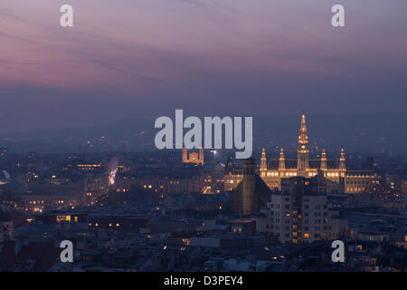 Vienna Cityscape: Rathaus at sunset. The view from the top of the Stephandom steeple. Including rathaus and the hills beyond. Stock Photo