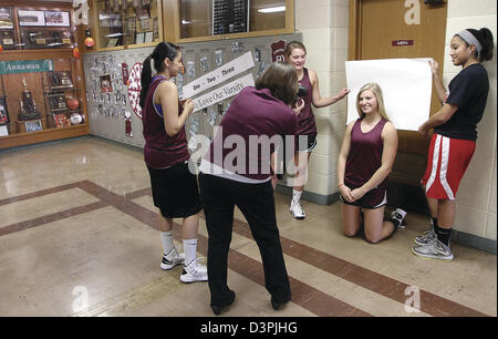 Feb. 20, 2013 - Annawan, Iowa, U.S. - Annawan High School teacher and yearbook photographer Gina Peterson, takes pictures of girls basketball player Megan Foes, and other members of the team Wednesday, Feb. 20, 2013, to make Big Heads on a stick for their semifinal game at the state tournament in Bloomington on Friday. (Credit Image: © John Schultz/Quad-City Times/ZUMAPRESS.com) Stock Photo