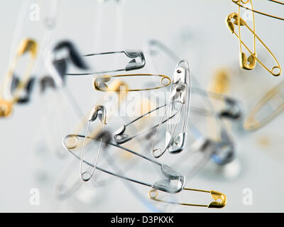 floating safety pin on a white background Stock Photo