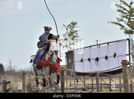 A yabusame archer misses the first shot but moves on to the next set of targets Stock Photo