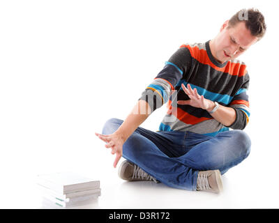 Exhausted and tired student with pile of books on white background Stock Photo