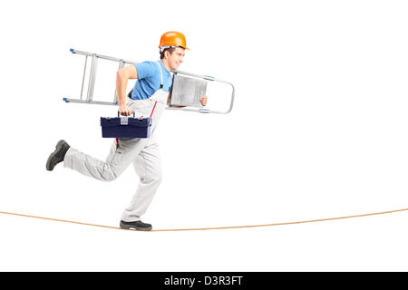 Full length portrait of a repairman running on a rope with a ladder and a tool box isolated on white background Stock Photo