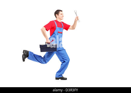 Full length portrait of a repairman running with a wrench and a tool box isolated on white background Stock Photo