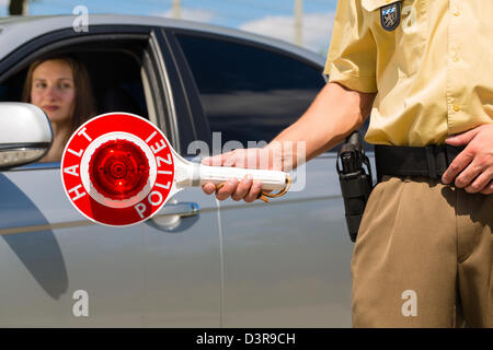 Police - policeman or cop in uniform stop car in traffic control Stock Photo