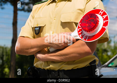 Police - policeman or cop in uniform stop car in traffic control Stock Photo