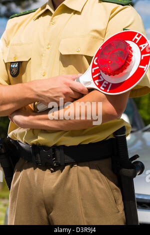 Police - policeman or cop in uniform stop car in traffic control Stock Photo