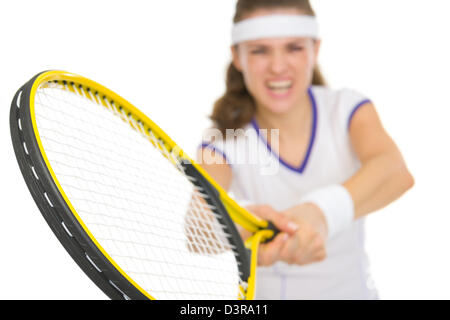Closeup on racket in hand of tennis player reflecting strike Stock Photo