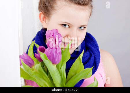 smiling teenager girl with pink tulips bouquet present gift easter mothersday valentine birthday Stock Photo