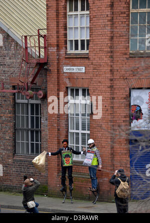Manchester, UK. 23rd February 2013. Protesters at the Manchester Coalition Against Cuts rally in Manchester pose for photos in Cameron Street. The protesters gather outside the Town Hall after marching through the city centre to the Town Hall to listen to speakers call for a general strike against the government cuts. Manchester, UK   23-02-2013 Credit:  John Fryer / Alamy Live News Stock Photo