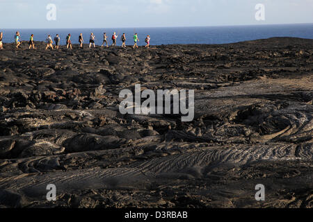 hikers on recent Pahoehoe lava from Kilauea Volcano Hawaii Stock Photo