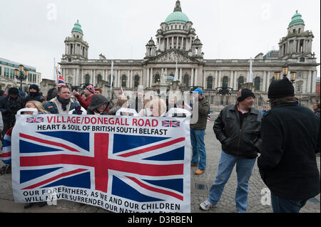 Belfast, UK. 23rd February 2013. Loyalist Union flag demonstrators stand in front of Belfast City Hall.  Street protests have been taking place since December 3, when Belfast City Council voted to reduce the number of days the Union flag is flown at City Hall. The protest was staged concurrently with a parade marking the 25th anniversary of two Ulster Defence Regiment men killed by an IRA bomb in 1988. Credit:  Lee Thomas / Alamy Live News Stock Photo