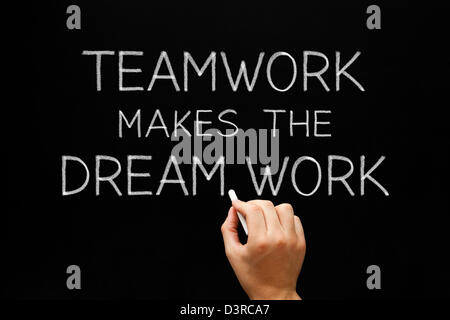 Hand writing Teamwork Makes The Dream Work with white chalk on a blackboard. Stock Photo