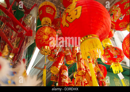 Red and gold lanterns and ornaments for Chinese New Year are on display in a shop. Stock Photo