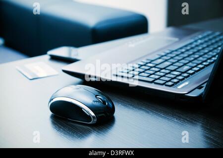 Laptop, mouse, credit card on desk Stock Photo