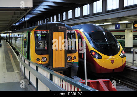 London Midland commuter train next to a Virgin Pendolino express train at London Euston Stock Photo