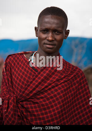 A Masai warrior dressed in the traditional garb. In a boma ouside Ngorongoro crater. Tanzania Stock Photo