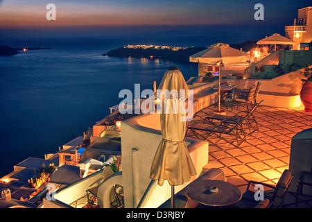 All houses in Santorini have amazing view of caldera & Aegean Sea for traditional sunset watch evening snack Stock Photo