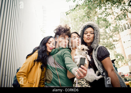 Hispanic/Latina women friends making faces taking selfie together Stock Photo