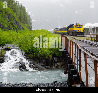 The Alaska Railroad depot and train, Whittier, Alaska, USA. A tunnel from Whittier to Portage is shared by autos and railroad. Stock Photo