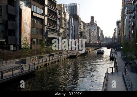 Dotonbori River canal lined with shops and buildings runs through heart of Namba shopping and entertainment district in Osaka. Stock Photo