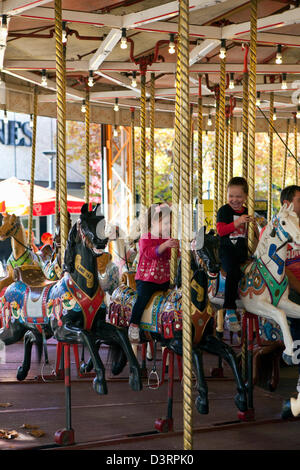 Kids enjoying the Canberra merry-go-round in Petrie Plaza. Canberra, Australian Capital Territory (ACT), Australia Stock Photo