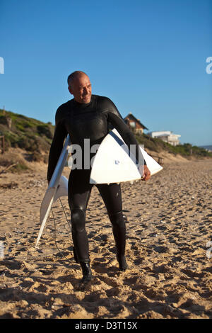 Surfer with broken board on beach, Jeffreys Bay, Indian Ocean, South Africa Stock Photo