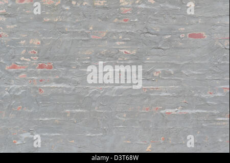 Wall of brick and gray stucco, close up of rough sandy uneven swirled finish, design element for backgrounds, textures Stock Photo