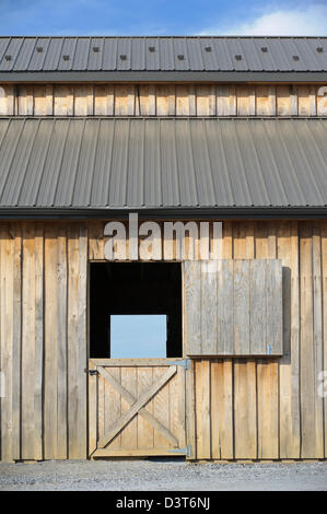 Open barn door and wooden wall for backgrounds and design elements, side view. Stock Photo