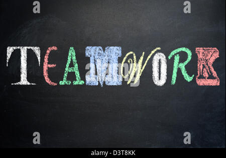 Working together concept, teamwork, diversity concept written with various letter fonts on a blackboard Stock Photo