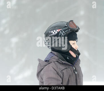 A boy wearing protective glasses views the partial solar eclipse from ...