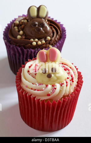 Easter cupcakes with white and milk chocolate bunny rabbits on isolated on white background Stock Photo