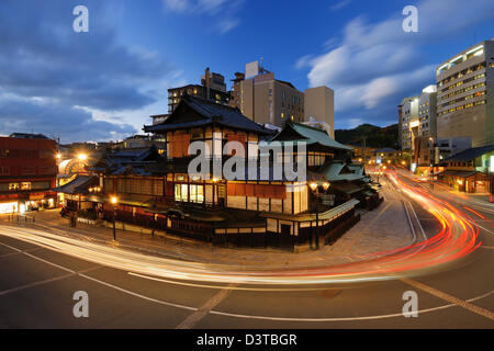 Dogo Onsen and the cityscape of Matsuyama, Japan. Dogo Onsen is one of the most famous hot spring bath houses in all of Japan.