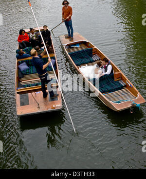 Asian bride and groom kissing in a punt on The Backs River Cam Cambridge Cambridgeshire England Europe