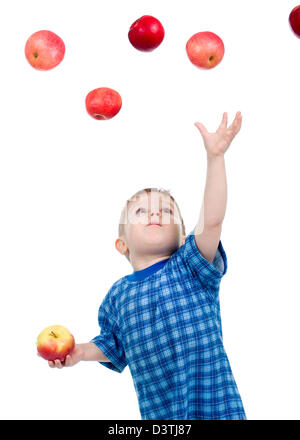 Little boy caughts flying apple .isolated on white background Stock Photo