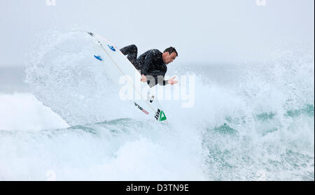 Surfer getting air, St Agnes, Cornwall, UK Stock Photo