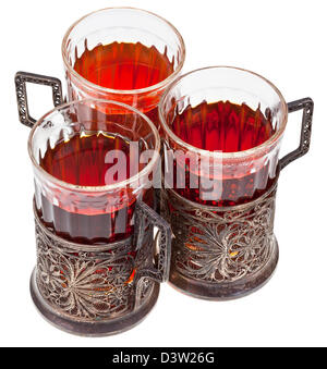 three retro glasses in silver glass holders with black tea isolated on white background Stock Photo