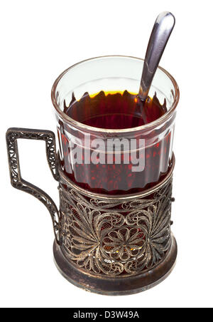 black tea in vintage glass with teaspoon and glass-holder isolated on white background Stock Photo