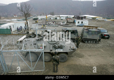 An armoured KFOR vehicle passes the gate of the fortified Bundeswehr camp 'Nothing Hill'  north of Mitrovica, Serbia, 11 December 2006. Administrated by the UN the Kosovo forms part of Serbia under international law. The camp erected only in July 2006 is the northernmost post of the KFOR troops in the Kosovo. Photo: Matthias Schrader Stock Photo