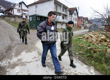 German Bundeswehr soldiers patrol with an interpreter the village ...