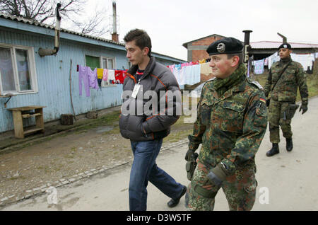 German Bundeswehr soldiers patrol with an interpreter the village ...