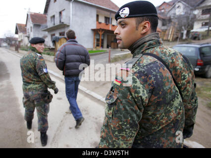 German Bundeswehr soldiers patrol with an interpreter the village ...