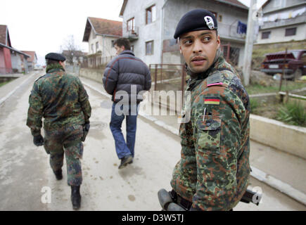 German Bundeswehr soldiers patrol with an interpreter the village ...