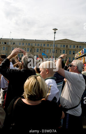 Crowds standing in Eastbourne in the UK to watch and photograph an air show. Stock Photo