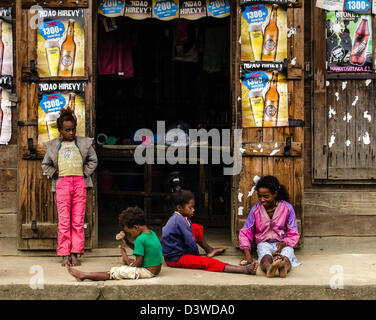 Children playing outside a food shop Andasibe village or Perinet Madagascar Stock Photo