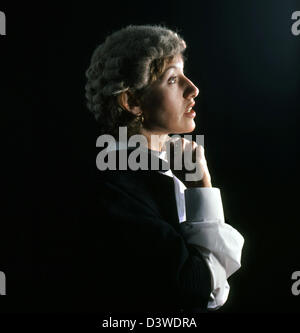 British woman Barrister in wig and gown .Profile black background Stock Photo
