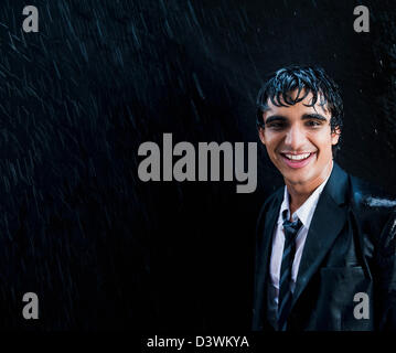 Businessman enjoying in the rain Stock Photo