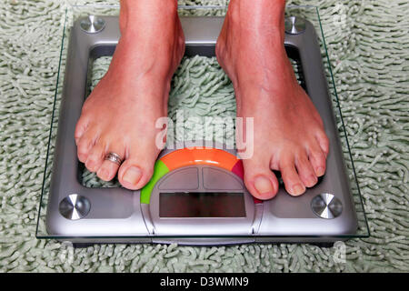 Bathroom scales isolated against green carpet Stock Photo